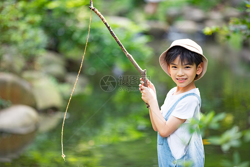 童真悠闲户外钓鱼的小男孩图片