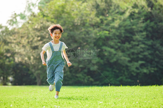 户外奔跑的童真小男孩图片