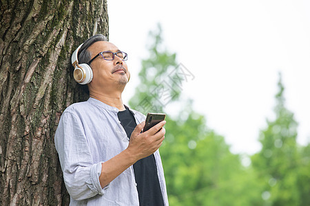 戴着耳机听音乐的中年男性图片