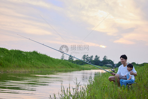 年轻爸爸带着儿子户外钓鱼图片