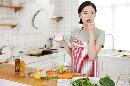 年轻女孩在厨房吃早饭高清图片