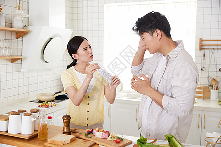 年轻情侣在厨房因账单而争吵图片
