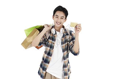 单肩背着购物袋拿着信用卡的年轻学生背景图片