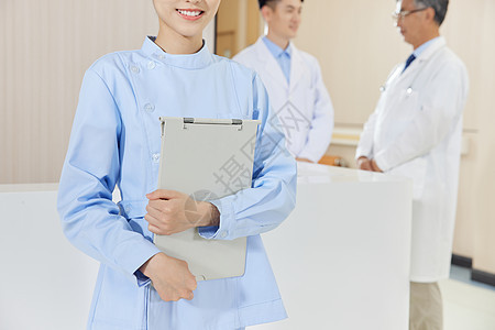 医院前台女性护士拿文件夹特写图片