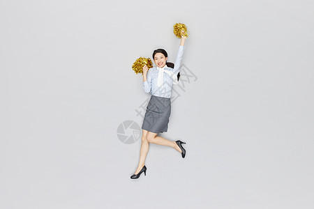 创意俯拍商务女性拿拉拉队手摇花加油图片