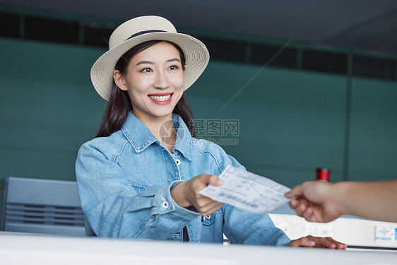 旅行的年轻女性办理登机牌图片