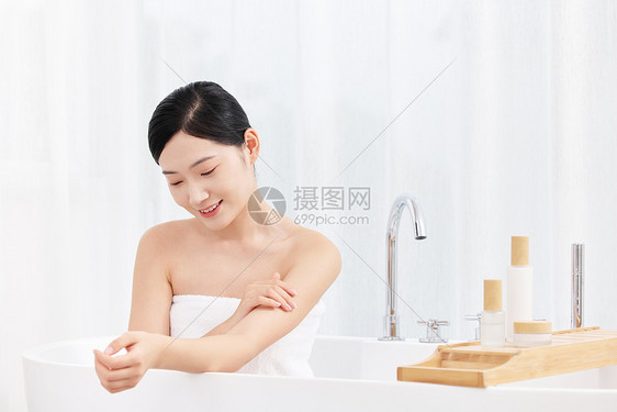 年轻女性沐浴后使用身体乳护肤图片