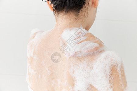 女性使用沐浴球洗澡背部特写图片素材