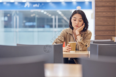 坐在咖啡店无聊等待的女性图片