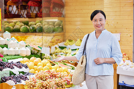 中年女性水果店购买水果背景图片