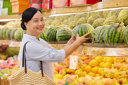 中年女性水果店内挑选西瓜图片