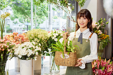 花艺店美女服务员手提花篮高清图片