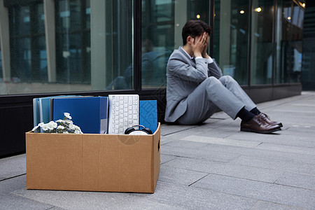 失业的职场商务男性瘫坐在地上图片