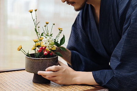 插花摆件日系男性手拿花枝插花特写背景