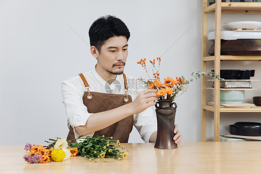 挑选花枝插花的青年男花艺师