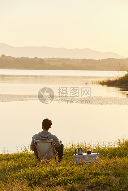 年轻男生坐在湖边背影图片