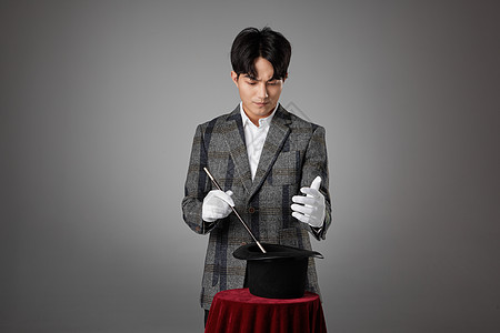 魔术棒手绘图男性魔术师手拿魔术棒正在变魔术背景