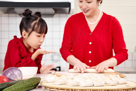 孙女陪伴奶奶厨房里包饺子图片