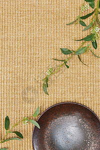 亚麻背景下的绿叶和盘子图片