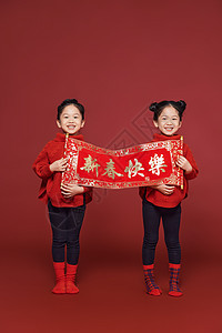 双胞胎小女孩姐妹新年拿春联图片