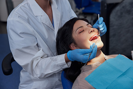 牙科医生为女性患者做牙齿治疗图片