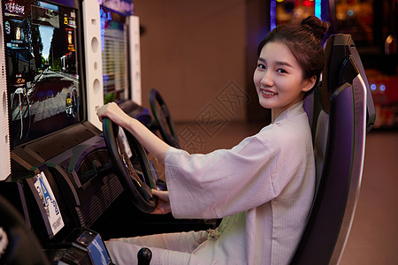 青年女性在游戏厅开赛车图片