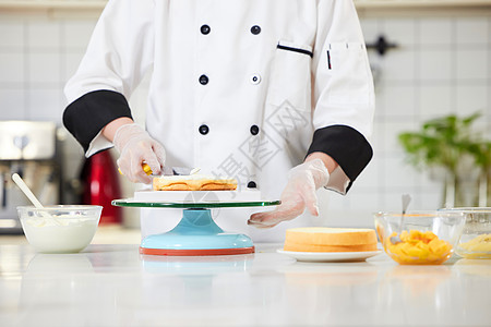 烘焙师往蛋糕胚上抹奶油特写食物高清图片素材