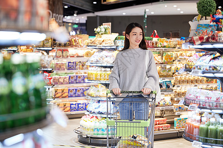 青年女性推手推车逛超市购物高清图片