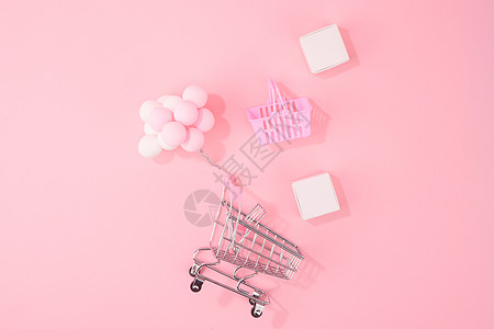 双十一放价嗨购粉色背景下的购物车创意概念背景