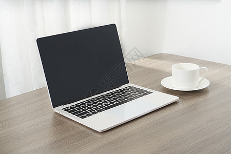 简约文具商务桌面上的咖啡杯和电脑背景