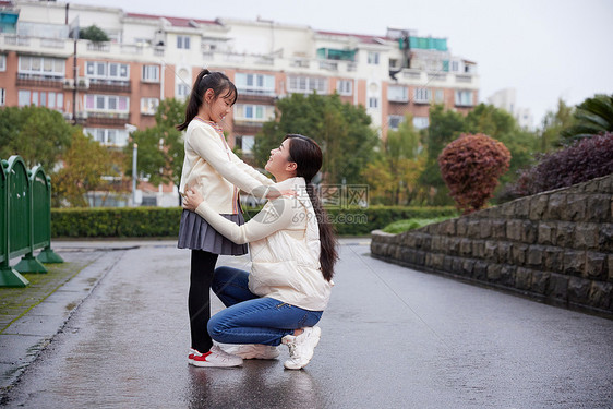 下雨天妈妈接送女儿上学图片