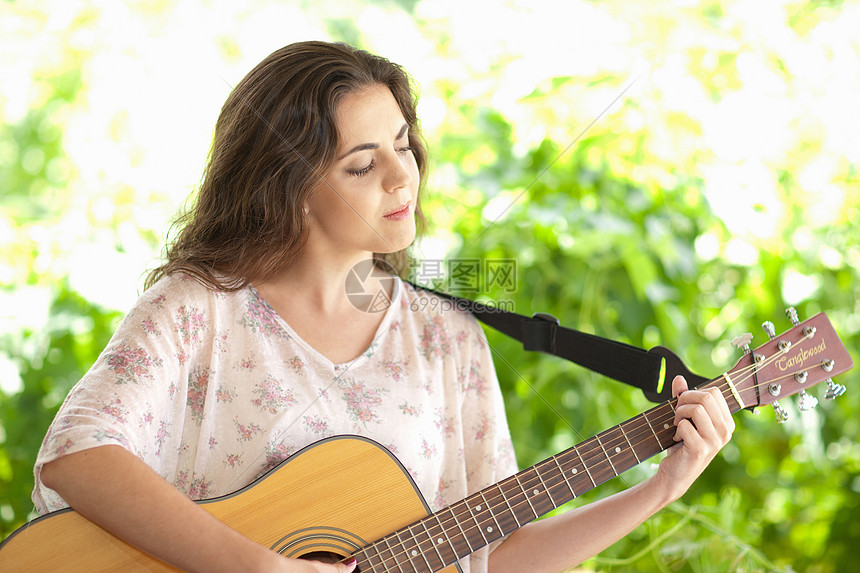 在户外弹吉他的女人图片