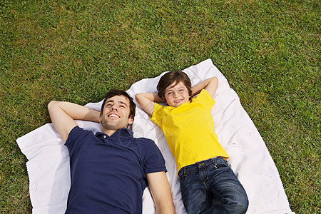 父亲和儿子躺在毯子上图片
