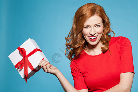 妇女拿着带红弓的白色礼物盒图片