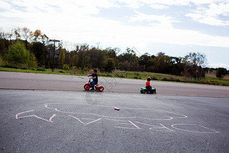 两个男孩骑三轮车图片