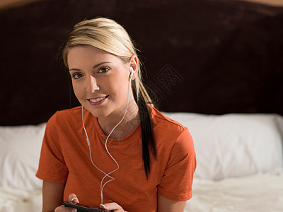 妇女在床上听音乐图片