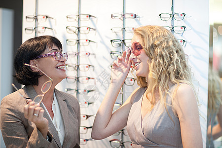 两名妇女在眼镜店试戴眼镜图片