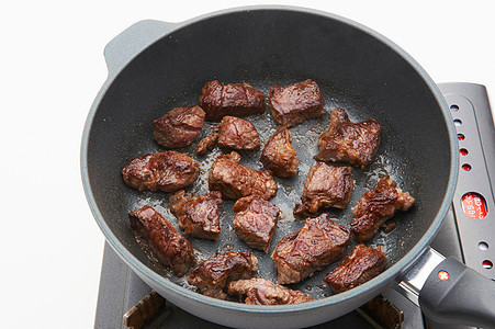 煎锅中的牛肉粒图片