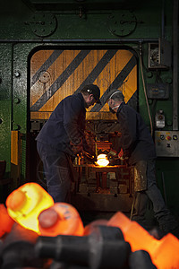 工人在锅炉边锻造钢铁图片