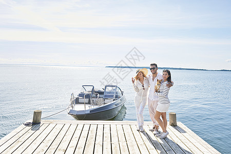 停靠着船的瑞典加夫勒码头站着三个青年
图片
