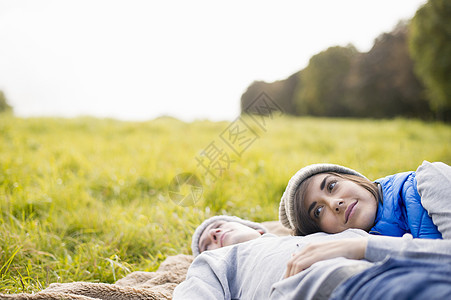 年轻女人在公园里趴在男友身上图片