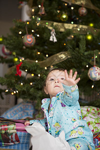 婴儿身后的圣诞节树背景图片