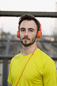 青年男跑者戴耳机的肖像图片