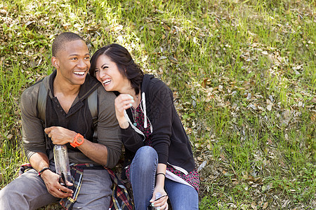 坐在公园草坪上的年轻夫妇图片