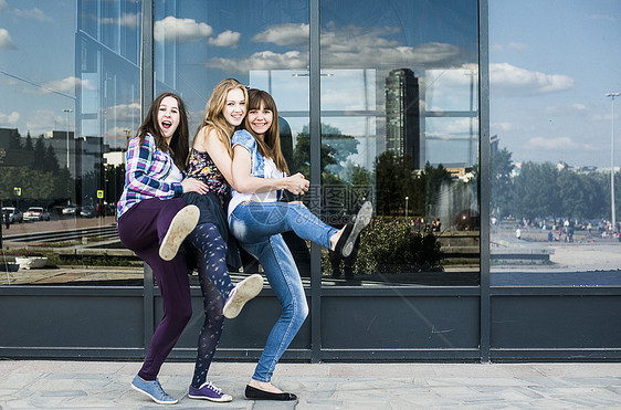 城市里三名女青年单脚跳舞图片