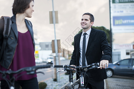 年轻女性和骑自行车上班的同事聊天图片