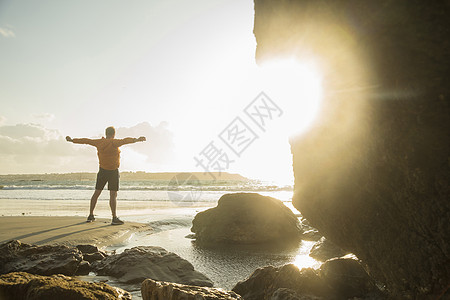 成熟的男子在海滩上运动看向海图片