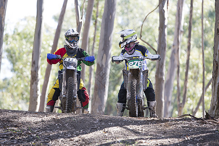 两个年轻的男运动骑手在森林里聊天图片