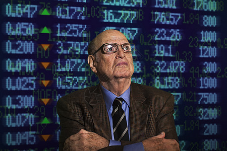 高级商人的肖像在金融数字显示面前折叠着图片