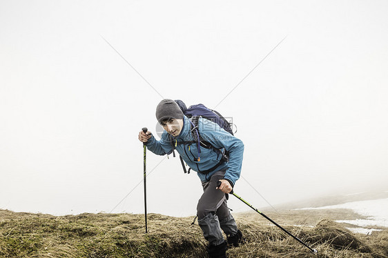 攀登山顶的成年男性图片